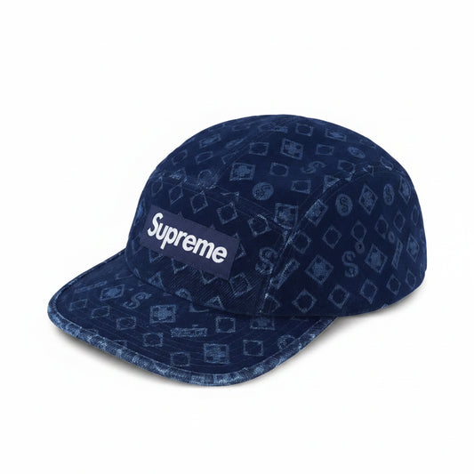 A Supreme 5-panel camp cap in navy blue velvet with a tonal monogram pattern and a white embroidered Supreme box logo on the front, shown on a plain white background.